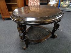 A continental low stained beech table with cherub mounts