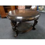 A continental low stained beech table with cherub mounts