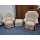 A pair of cream leather armchairs with matching footstool