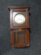 An early 20th century oak cased wall clock with silvered dial