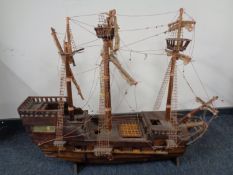 A hand built wooden model of a three masted galleon on stand