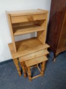 A nest of oak tables together with a small pine telephone table