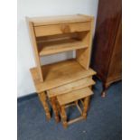 A nest of oak tables together with a small pine telephone table