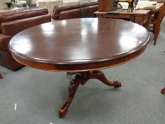 A Victorian mahogany tilt topped circular table and four reproduction chairs