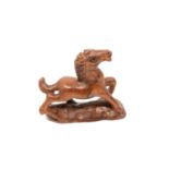 A carved Chinese hardwood netsuke - Cantering foal
