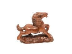 A carved Chinese hardwood netsuke - Cantering foal