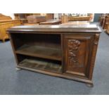 A continental carved oak low bookcase