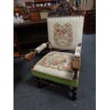 A 19th century oak carved armchair with tapestry seat