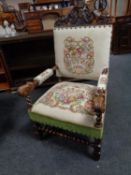 A 19th century oak carved armchair with tapestry seat