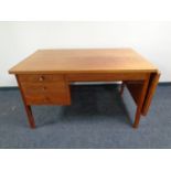 A mid century desk with drop end