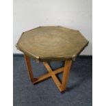 A brass topped occasional table on oak base