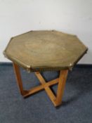 A brass topped occasional table on oak base