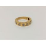 An 18ct gold diamond set half eternity ring, approx. 0.