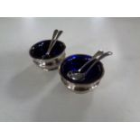 A small pair of silver salts with spoons