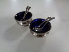 A small pair of silver salts with spoons