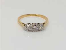 An 18ct gold three stone diamond ring, size P CONDITION REPORT: 2.