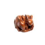 A carved Chinese hardwood netsuke - Two rabbits