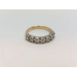 An 18ct white gold seven stone diamond half eternity ring, approximately 0.7ct, size P.