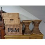 Three wicker baskets together with a pair of plant stands