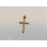 An 18ct yellow gold diamond cross pendant, the seventeen diamonds approximately 0.6ct.