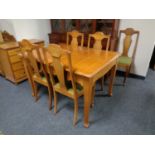 A continental pine dining room table together with five chairs