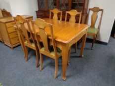 A continental pine dining room table together with five chairs