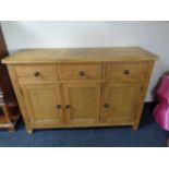 A light oak three drawer sideboard