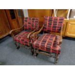 Two oak framed armchairs in red and black upholstery