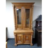 A 19th century oak glazed bookcase with covered base