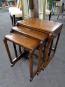 A nest of three oak tables