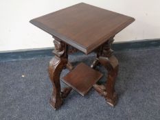 A 19th century occasional table on heavily carved figured legs