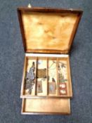 An antique wooden box containing sewing accessories,