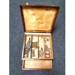 An antique wooden box containing sewing accessories,