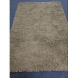 A contemporary olive shaggy pile rug