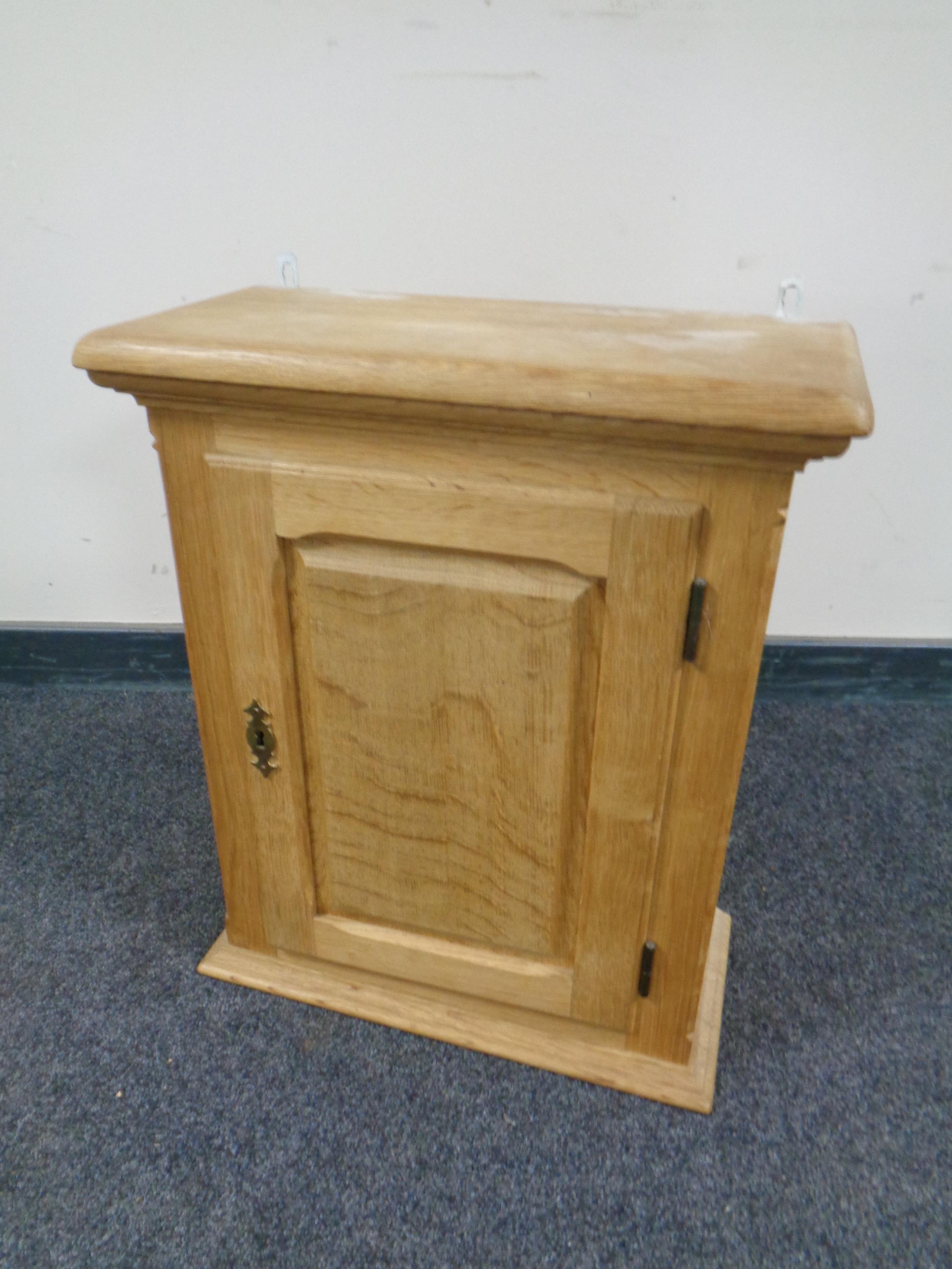 A light oak wall cabinet