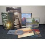 A group of framed and unframed canvas pictures, landscapes,