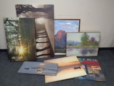 A group of framed and unframed canvas pictures, landscapes,