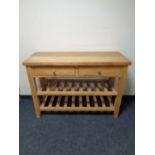 A light oak two drawer serving table