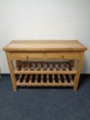 A light oak two drawer serving table