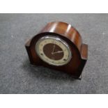 An early 20th century mahogany cased mantel clock with key and pendulum