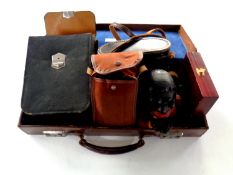 Two leather brief cases containing cast metal money box, leather cased travel set, boxed pen knife,