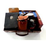 Two leather brief cases containing cast metal money box, leather cased travel set, boxed pen knife,