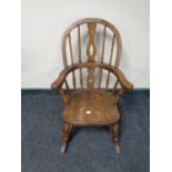 An antique small Windsor style rocking chair