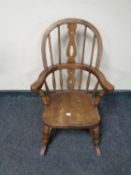An antique small Windsor style rocking chair