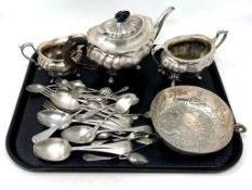 A three piece silver plated tea service together with a continental white metal bowl and a quantity