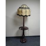 A mahogany standard lamp table with shade