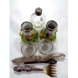 A cut glass silver rimmed perfume bottle together with a pair of cut glass silver rimmed salts,