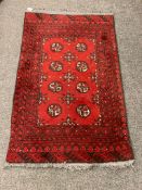 An Afghan Bokhara rug on red ground,