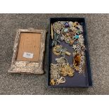 A silver mounted photograph frame, together with costume jewellery including brooches,