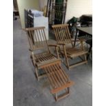 A pair of teak reclining steamer chairs with footstool.